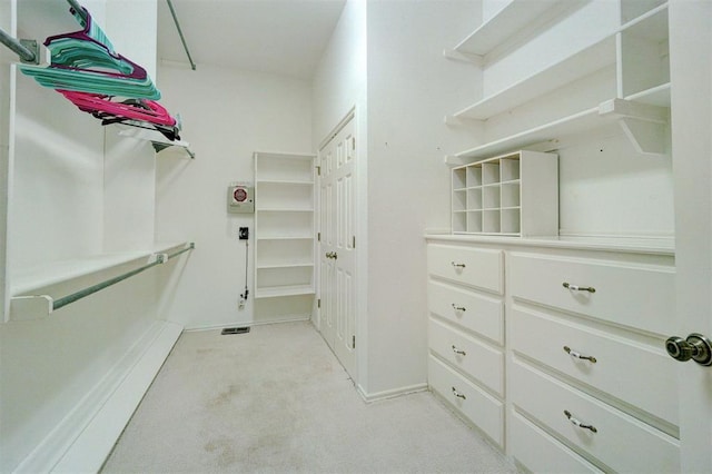 spacious closet featuring light carpet