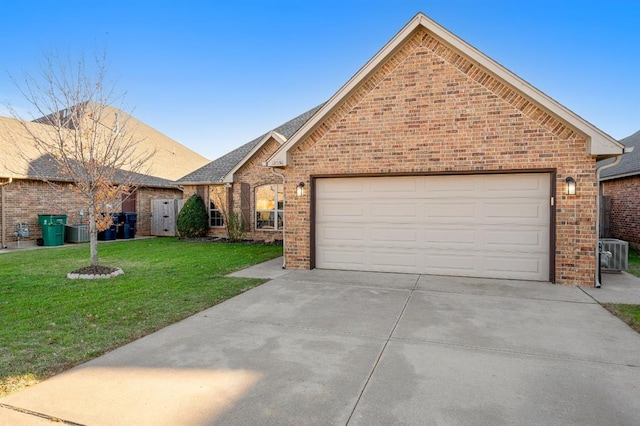 view of front of property with a front yard, central AC, and a garage