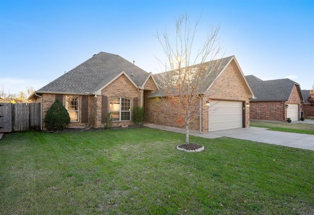 view of front of property with a front yard and a garage