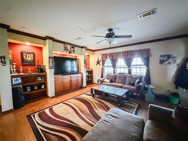 living room with light hardwood / wood-style flooring, ceiling fan, and ornamental molding