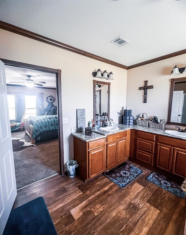 bathroom featuring wood-type flooring, vanity, ceiling fan, and ornamental molding