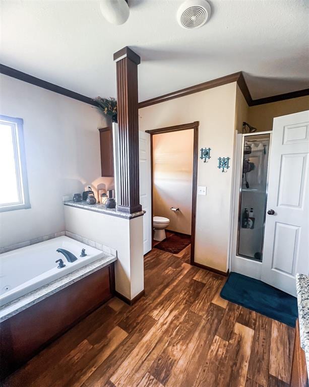 bathroom with hardwood / wood-style floors, toilet, crown molding, and independent shower and bath