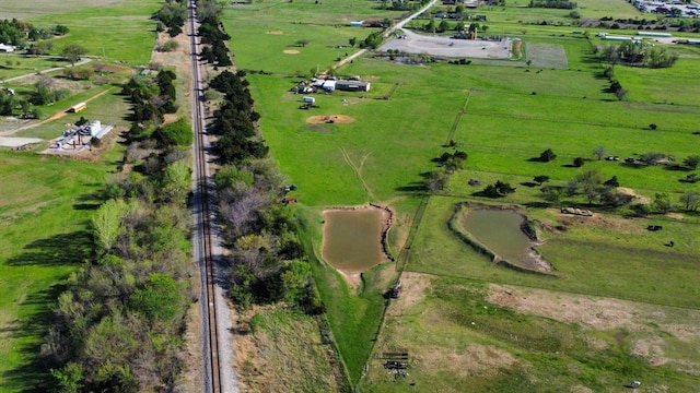 birds eye view of property with a rural view and a water view