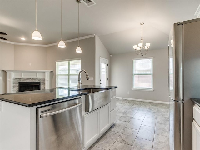 2213 Waterbrook Ct, Norman, OK 73026 - kitchen featuring stainless steel appliances, light marble finish flooring, a sink, plenty of natural light, and vaulted ceiling