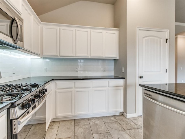 2213 Waterbrook Ct, Norman, OK 73026 - kitchen featuring stainless steel appliances, lofted ceiling, tasteful backsplash, and white cabinetry