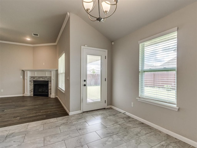 2213 Waterbrook Ct, Norman, OK 73026 - unfurnished living room featuring plenty of natural light, crown molding, a fireplace, a chandelier, and marble look tiles