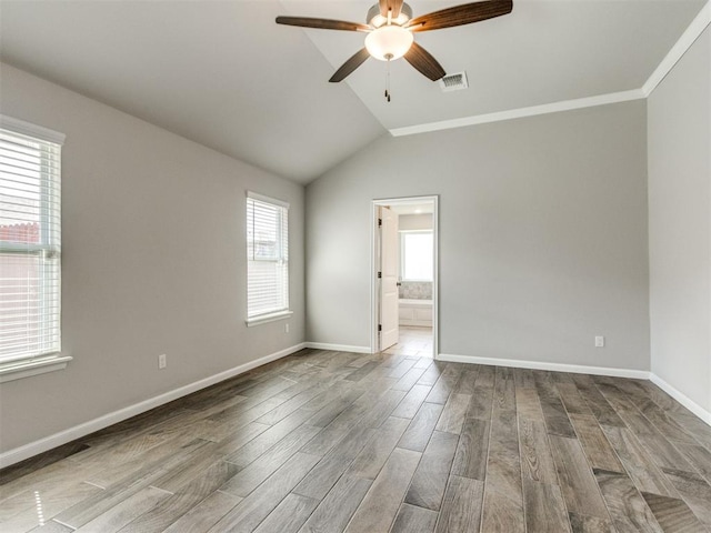 2213 Waterbrook Ct, Norman, OK 73026 - empty room with ceiling fan, wood finished floors, baseboards, and lofted ceiling