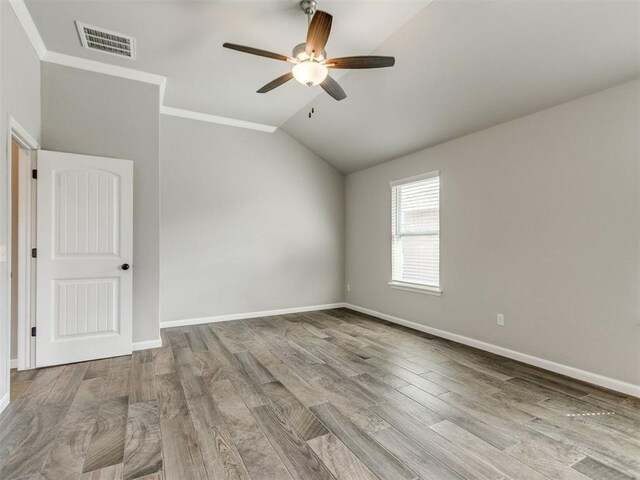 2213 Waterbrook Ct, Norman, OK 73026 - spare room with a ceiling fan, wood finished floors, vaulted ceiling, baseboards, and ornamental molding