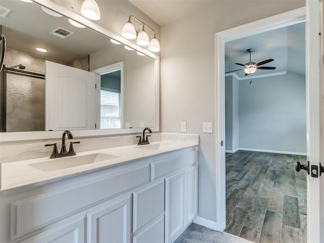 2213 Waterbrook Ct, Norman, OK 73026 - full bathroom featuring a ceiling fan, double vanity, an enclosed shower, vaulted ceiling, and baseboards
