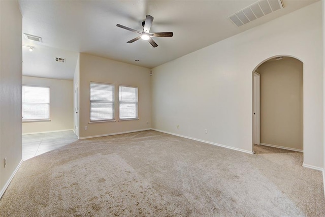 carpeted spare room with ceiling fan