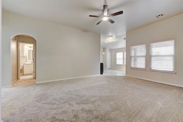 carpeted spare room with ceiling fan