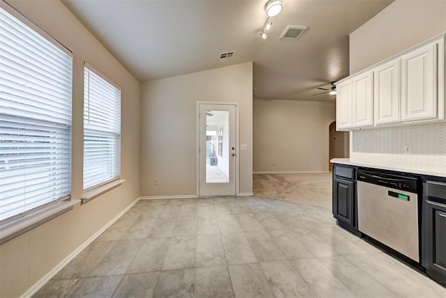 kitchen with white cabinetry, dishwasher, ceiling fan, track lighting, and lofted ceiling