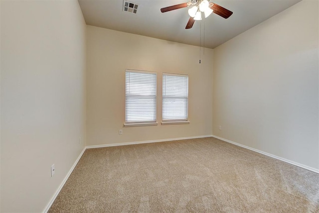 empty room with ceiling fan and light carpet