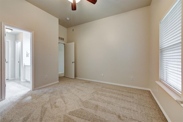 unfurnished bedroom featuring light colored carpet and ceiling fan