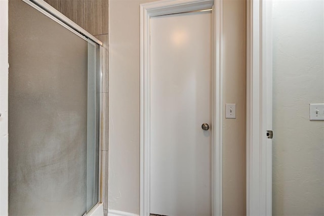 bathroom with a shower with shower door