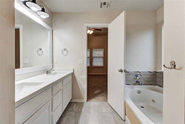 bathroom with vanity, a bathtub, and ceiling fan