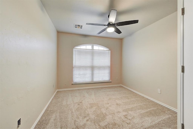 carpeted spare room featuring ceiling fan