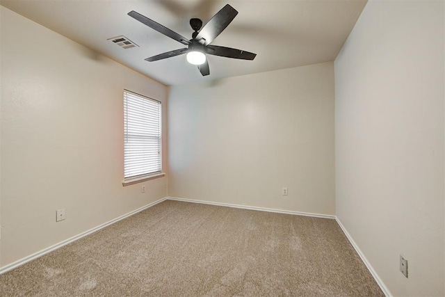 spare room featuring ceiling fan and light colored carpet