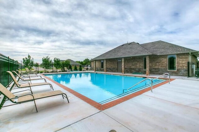 view of swimming pool with a patio