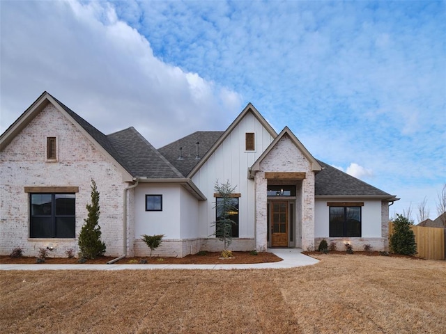 modern inspired farmhouse featuring a front lawn