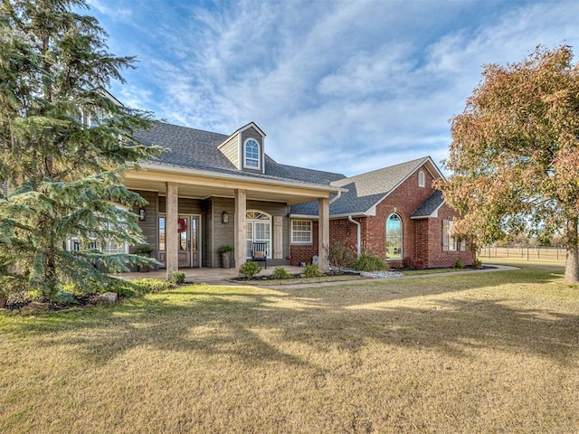 view of front of house featuring covered porch and a front yard