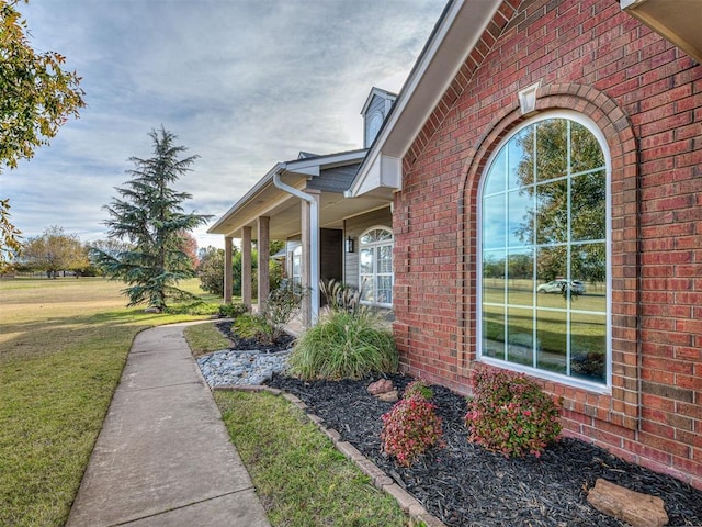 view of side of property with a lawn