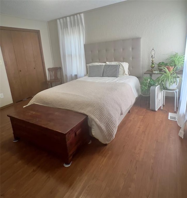 bedroom featuring light hardwood / wood-style floors and a closet