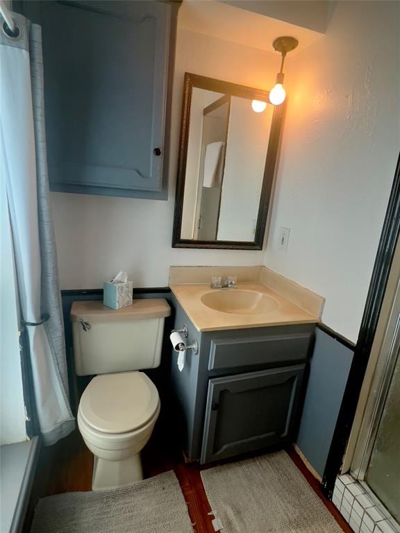 bathroom featuring vanity and toilet