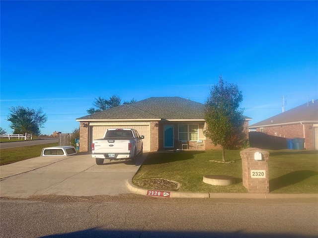 single story home featuring a front lawn and a garage