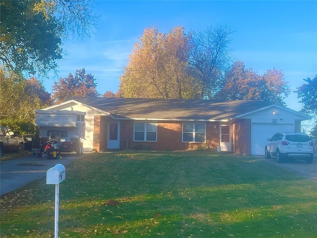 ranch-style house featuring a garage and a front lawn