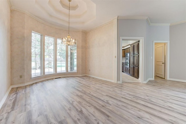 unfurnished dining area featuring crown molding, light hardwood / wood-style flooring, and a chandelier