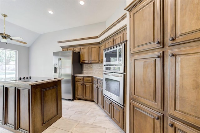 kitchen featuring a center island, backsplash, vaulted ceiling, ceiling fan, and stainless steel appliances