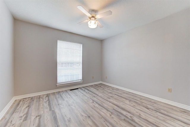 empty room with ceiling fan and light wood-type flooring