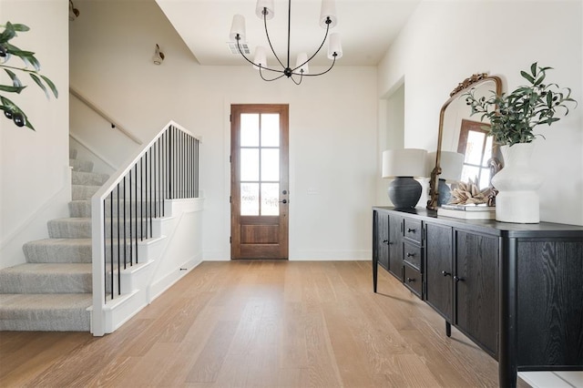 entryway with a chandelier and light hardwood / wood-style floors