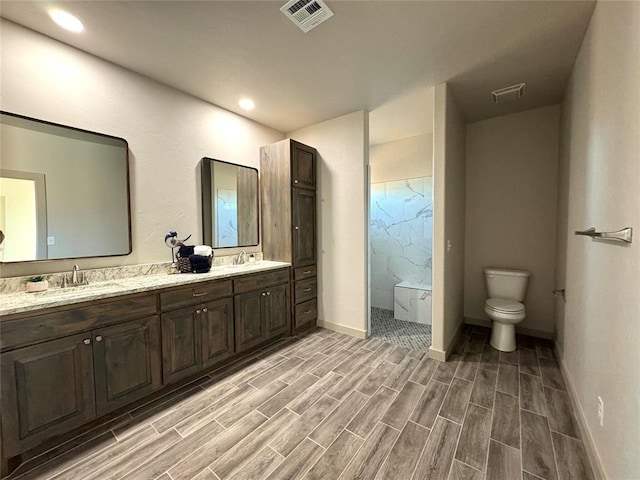 bathroom featuring toilet, vanity, wood-type flooring, and walk in shower