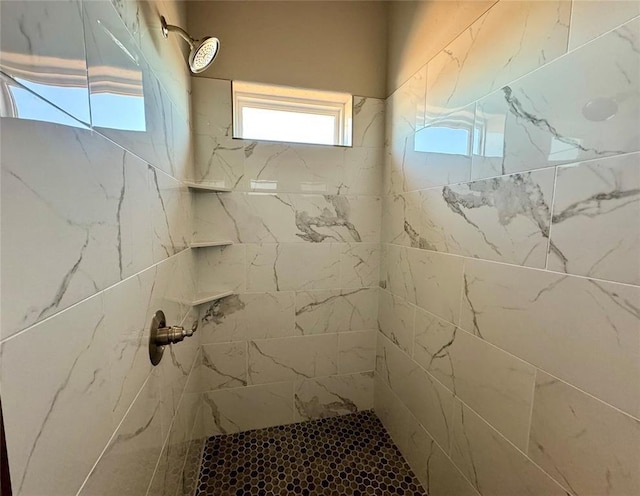 bathroom with a tile shower