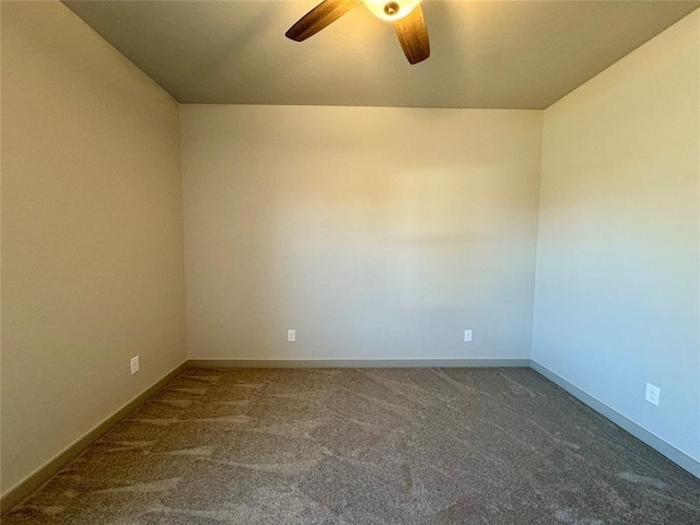 spare room featuring ceiling fan and carpet