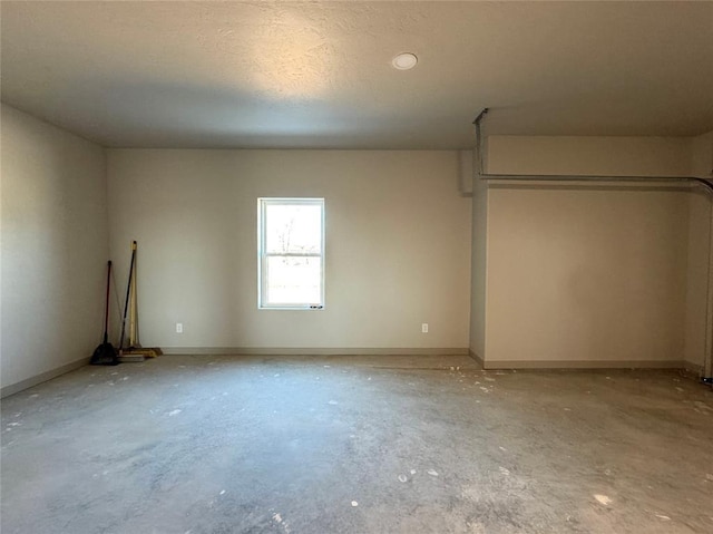 unfurnished room with concrete flooring