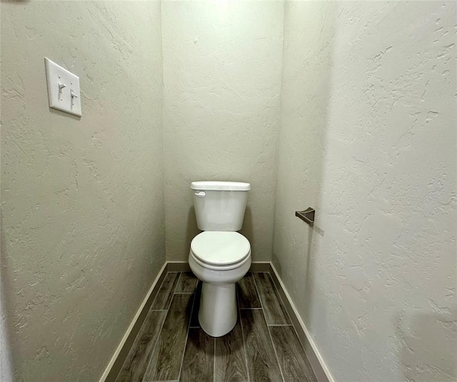 bathroom featuring hardwood / wood-style floors and toilet