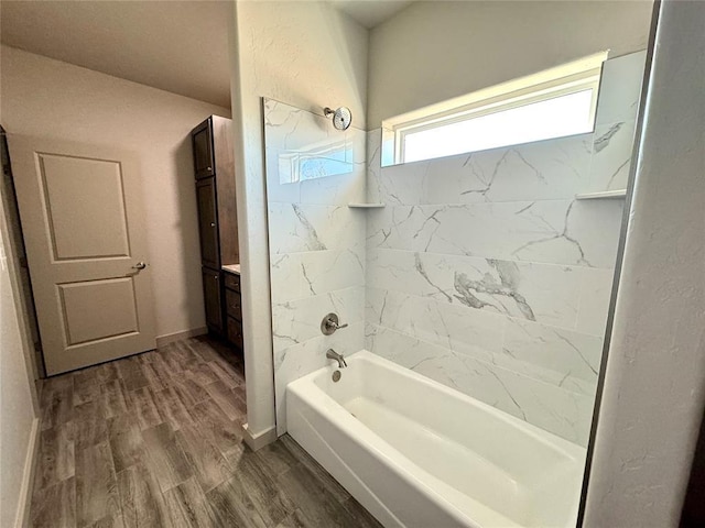 bathroom with vanity, hardwood / wood-style floors, and tiled shower / bath combo