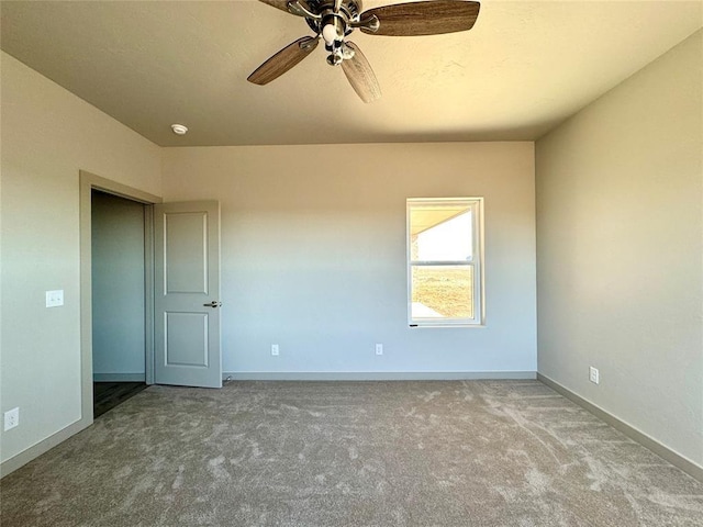 carpeted empty room featuring ceiling fan