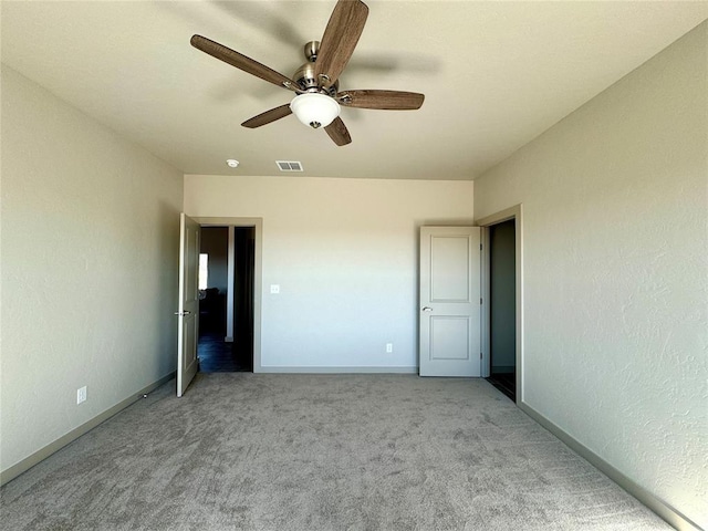 unfurnished bedroom featuring light colored carpet and ceiling fan