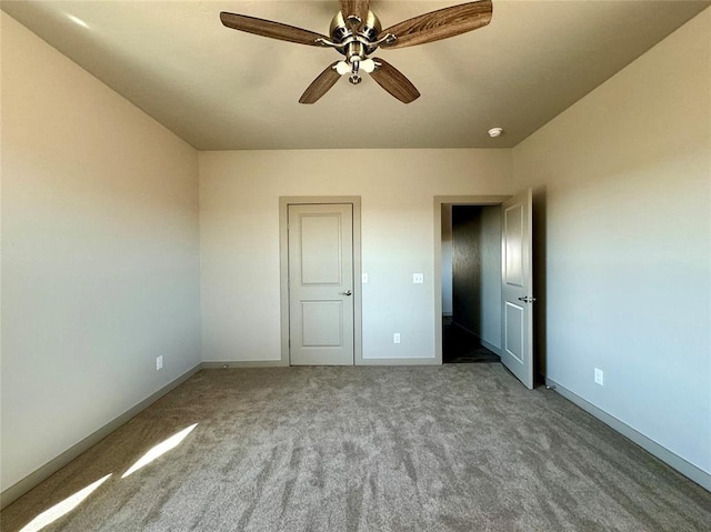 unfurnished bedroom featuring ceiling fan and carpet floors