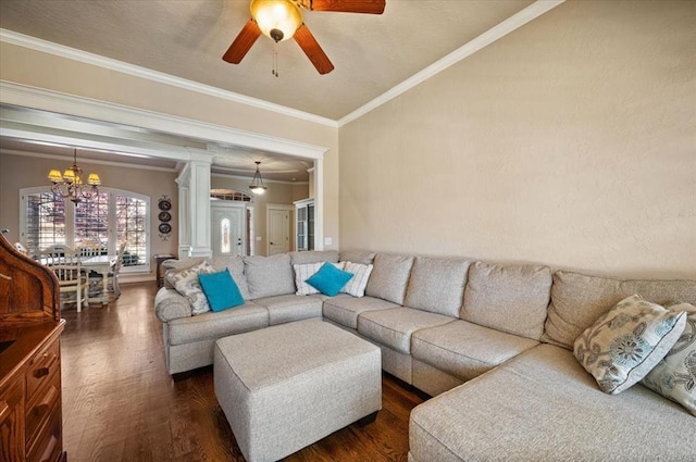 living room with decorative columns, ornamental molding, ceiling fan with notable chandelier, and dark hardwood / wood-style flooring