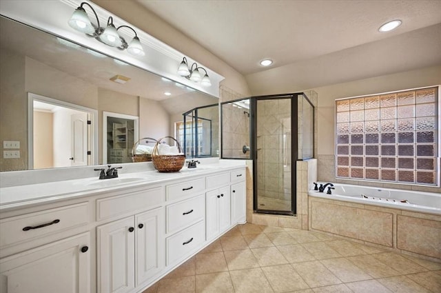 bathroom featuring plus walk in shower, vaulted ceiling, a wealth of natural light, vanity, and tile patterned floors