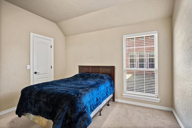 carpeted bedroom with vaulted ceiling