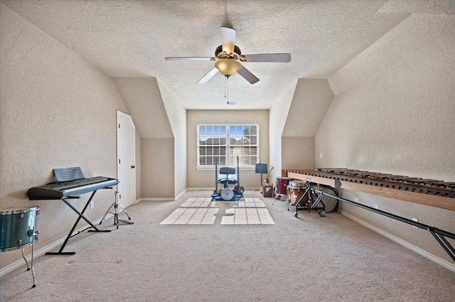 interior space with light colored carpet, ceiling fan, vaulted ceiling, and a textured ceiling