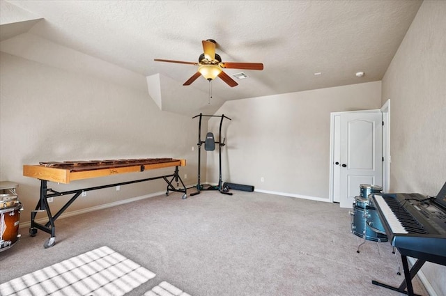 playroom featuring lofted ceiling, a textured ceiling, light colored carpet, and ceiling fan