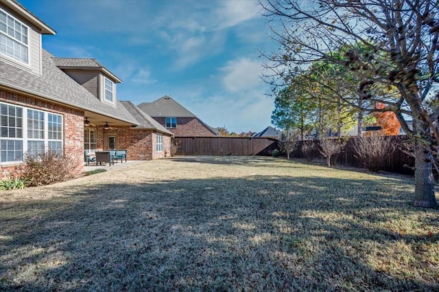 view of yard with ceiling fan and a patio area