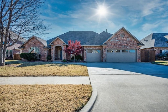 ranch-style home featuring a garage and a front lawn